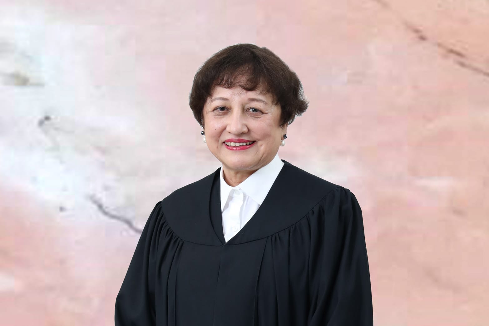 Portrait of a woman in a black judicial robe with a white collared shirt.